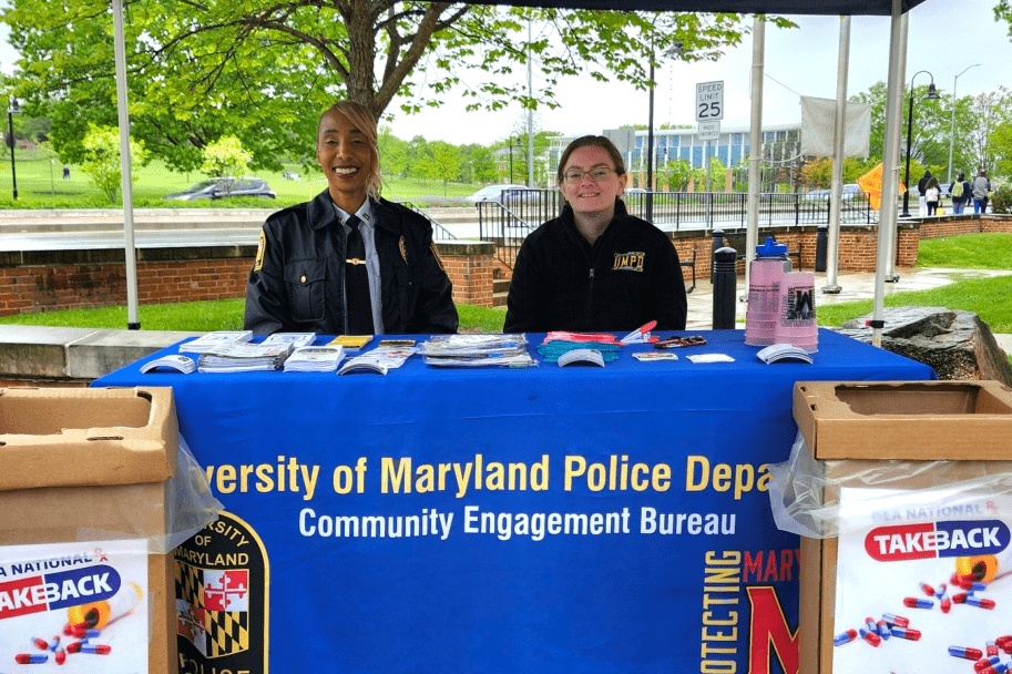 officer and student employee at community take back event